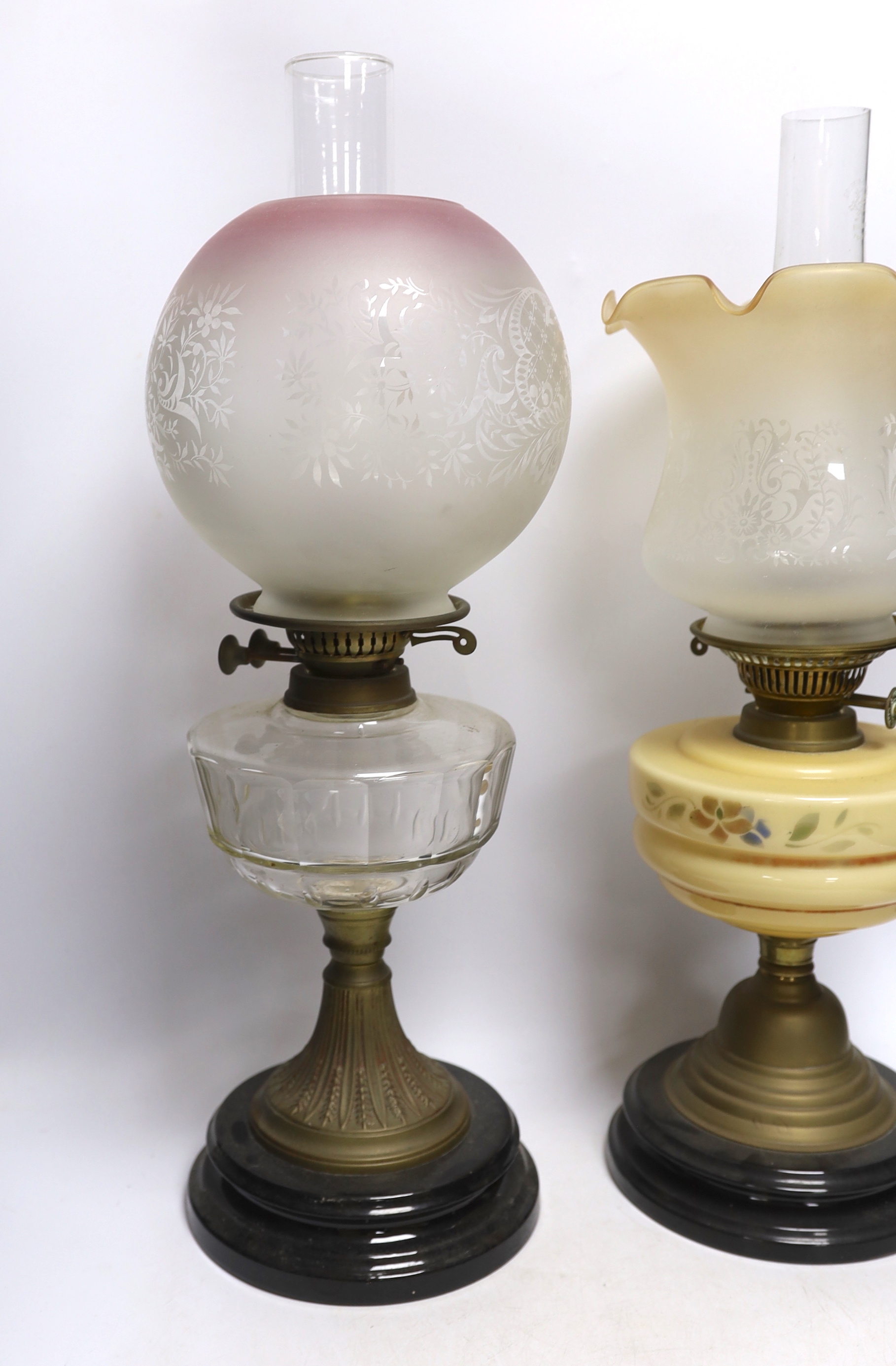 Three glass and brass oil lamps, c.1900, tallest 57cm